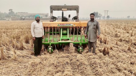 Jagdeep Singh (right) with his happy seeder machine.