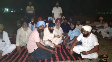 A dharna was undertaken by farmers within the sugar mill premises after the auction was postponed (Express)