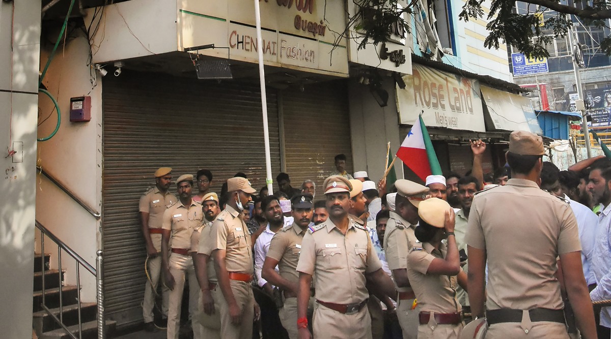 Security personnel speak with Popular Front of India (PFI) workers protesting against the raid of NIA at the PFI office, in Chennai (PTI photo)