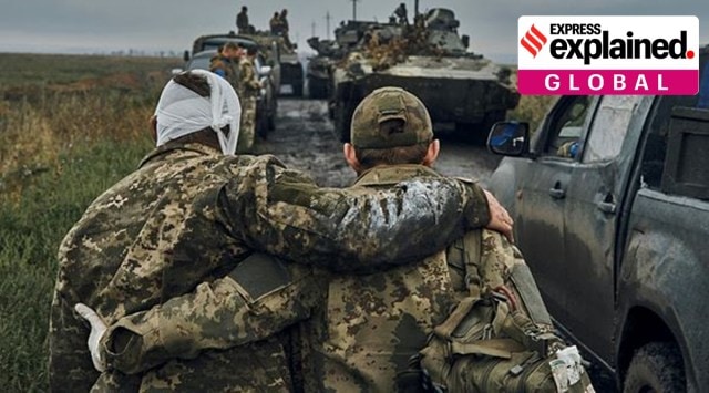A Ukrainian soldier helps a wounded fellow soldier on the road in the freed territory in the Kharkiv region, Ukraine, Monday, Sept. 12, 2022.  (AP/PTI)