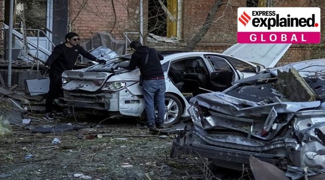 Local residents check their car, destroyed by the previous day's Russian military strike, as Russia's attack on Ukraine continues, in central Kyiv, Ukraine October 11, 2022. REUTERS/Gleb Garanich