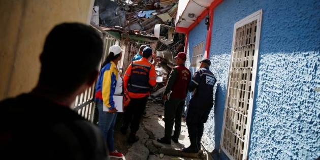 Rescue workers help people evacuate from venezuela