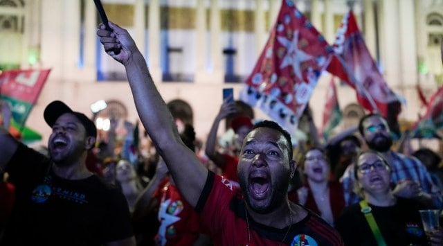 Followers of former Brazilian President Luiz Inacio Lula da Silva, who is running for president again, react to partial results after general election polls closed in Rio de Janeiro, Brazil, Sunday, Oct. 2, 2022. (AP)