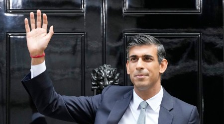 New British Prime Minister Rishi Sunak waves after arriving at Downing Street in London, Oct. 25, 2022, after returning from Buckingham Palace where he was formally appointed to the post by Britain's King Charles III. (AP)