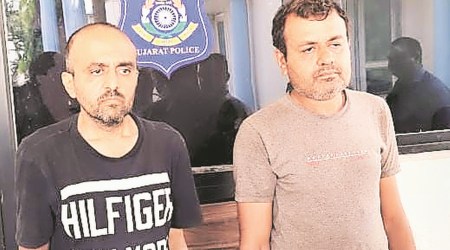 Bhavesh Akbari (left) and his elder brother Dilip in police custody on Thursday. (Express photo by Sardarsinh Chauhan)