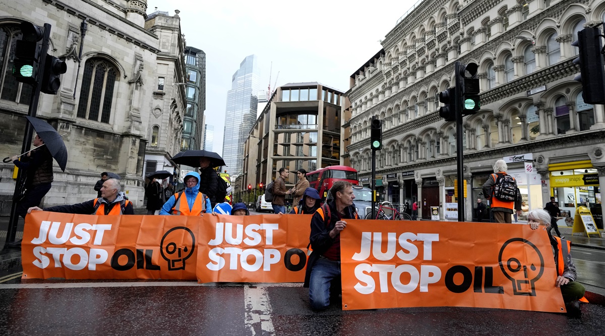 Activists from the group Just Stop Oil block a road in London, Thursday, Oct. 27, 2022 demanding to stop future gas and oil projects from going ahead.(AP Photo/Kirsty Wigglesworth)