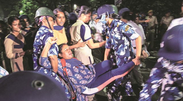 A woman being removed from the sit-in demonstration site in Salt Lake Friday morning. PTI