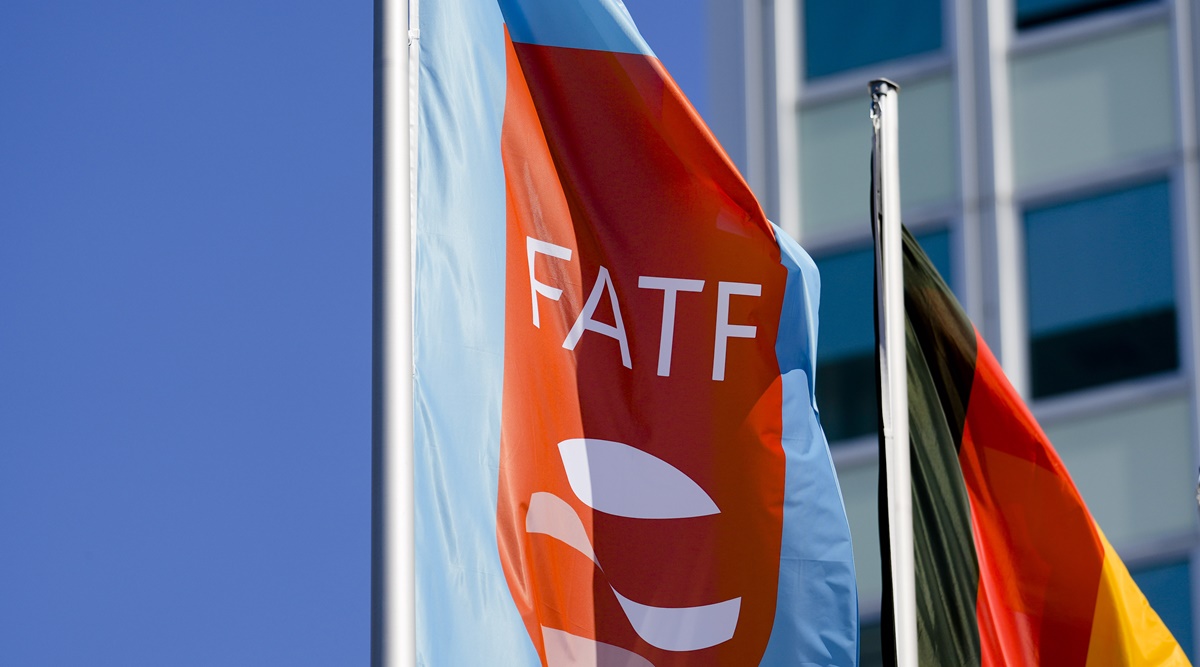 FILE - A flag with the logo of the Financial Action Task Force, FATF, waves in the wind next to the German national flag during a meeting of the task force at the Congress Center in Berlin, Germany, Friday, June 17, 2022. (AP Photo/File)