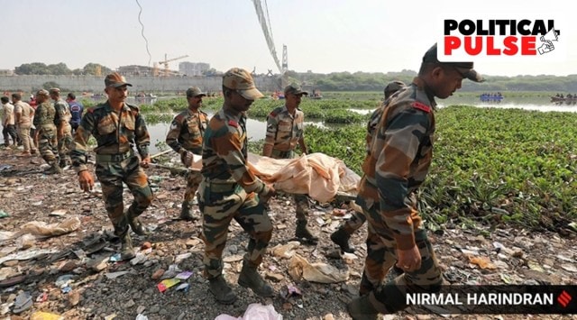 Rescue personnel retrieve a body in Morbi. (Express Photo)