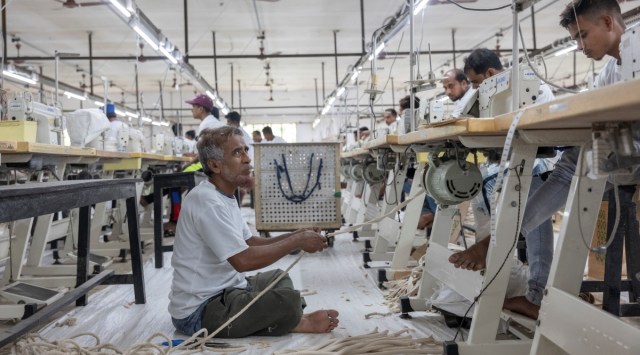 A worker pulling handles for reusable bags at the Ballyfabs International factory in Begumpur, India, where the country’s jute industry is concentrated, Aug. 31, 2022. (The New York Times)