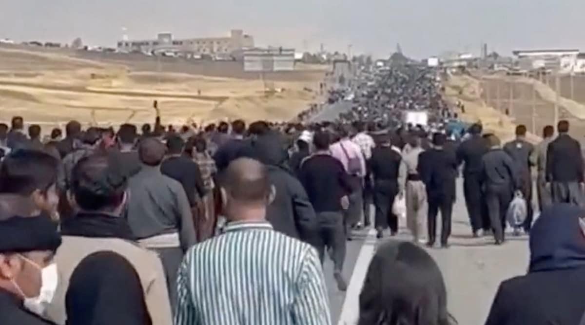 People march down the highway toward the Aychi Cemetery, where Mahsa Amini is buried, near Saqez, Iran, in this screengrab taken from a social media video released October 26, 2022 and obtained by REUTERS. 