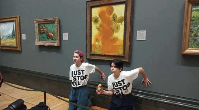 Just Stop Oil of two protesters who have thrown tinned soup at Vincent Van Gogh's famous 1888 work Sunflowers at the National Gallery in London, Friday Oct. 14, 2022. (AP)