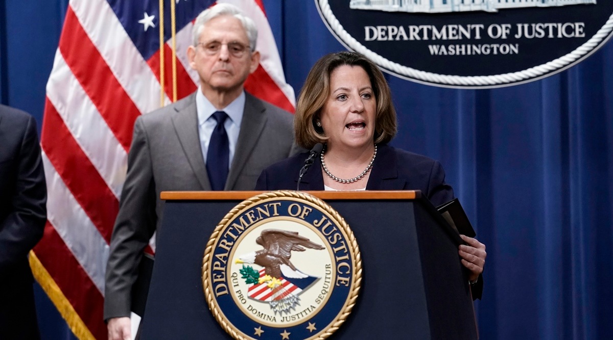 Deputy Attorney General Lisa Monaco, center, joined at left by Attorney General Merrick Garland, speaks to reporters as they announce charges against two men suspected of being Chinese intelligence officers for attempting to obstruct a US criminal investigation and prosecution of Chinese tech giant Huawei, at the Department of Justice in Washington, Oct. 23, 2022. (AP)