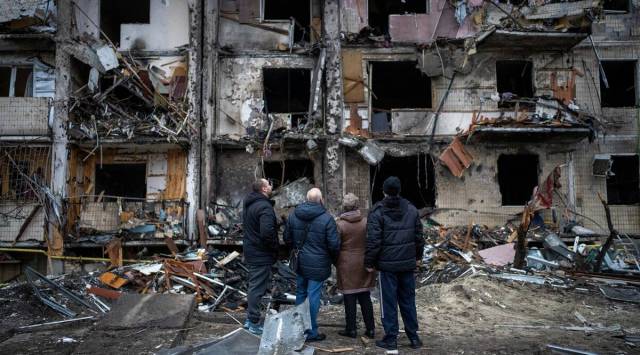 People look at the damage following a rocket attack in the city of Kyiv. (AP)