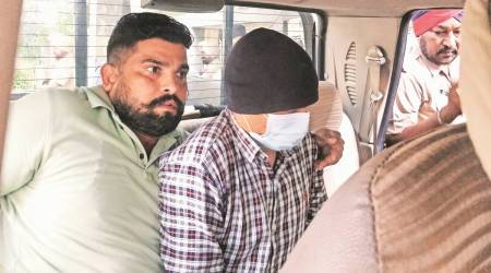 Arrested Armyman Sanjeev Singh (wearing a mask) being produced in court in Kharar, on Monday, (Express Photo by Jasbir Malhi)