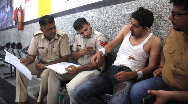 Panchkula police personnel with the collection agent who was attacked, at the Panchkula civil hospital on Monday. (Express photo by Jaipal Singh)