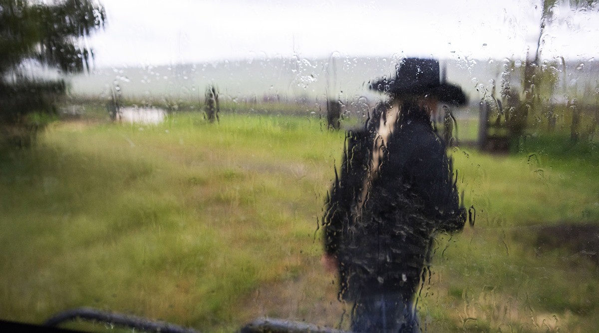 Shelby Kayser in the spring rain at her family's ranch near Centerville in May (New York Times)