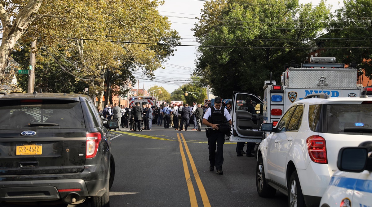 Police officers and emergency workers surround the home of Peter Zisopoulos, the suspect in the stabbing of a paramedic, in Queens on Thursday. (New York Times)