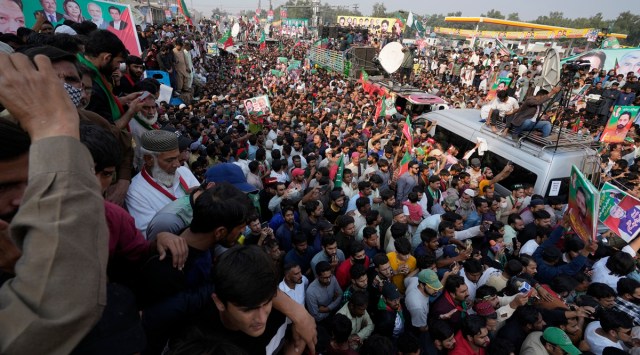 Supporters of Pakistan's main opposition 'Tehreek-e-Insaf party' listen the speech of their leader Imran Khan at a rally in Lahore, Pakistan, Saturday, Oct. 29 2022. (AP File Photo/K.M. Chaudary)