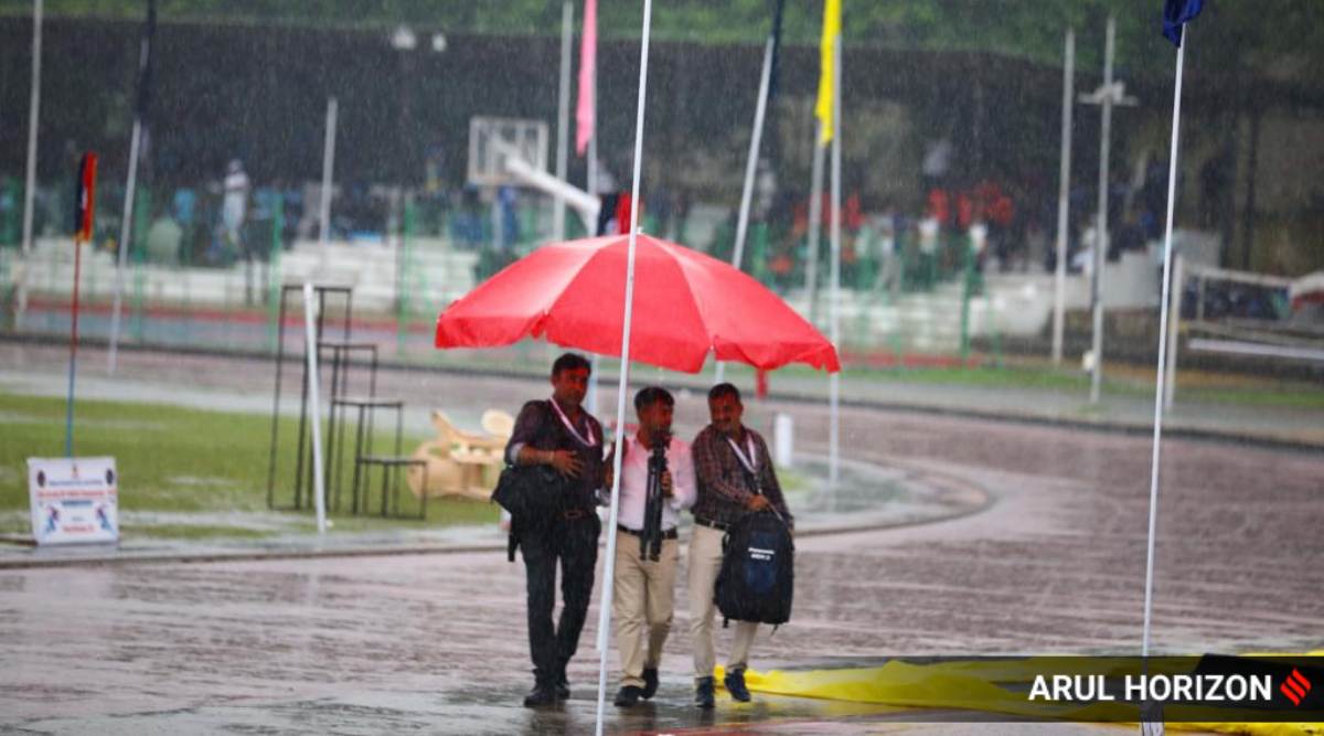 People cover up as it started pouring during the valedictory ceremony of 29th All India RPF (Railway Protection Force) Athletic Championship 2022 at AFMC stadium on Friday. The ceremony at the stadium was then  called off and shifted to another venue.