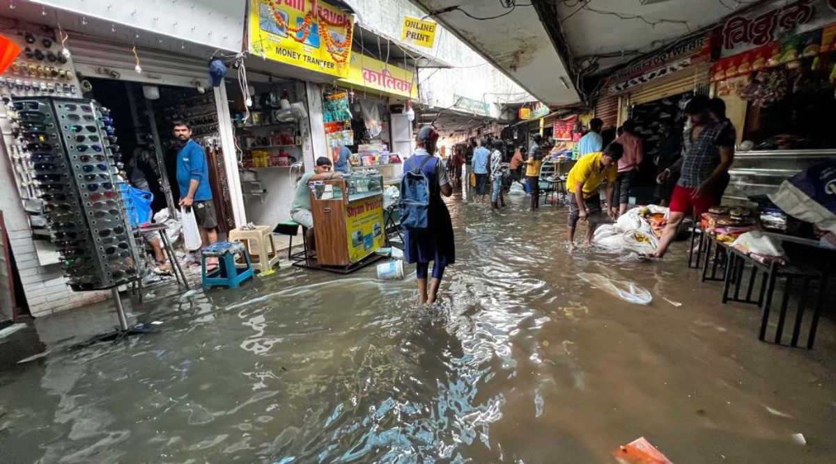Traders trying to save their commodities after the water entered the Subway at Pune Railway station in the heavy rains on Monday night. (Express photo by Arul Horizon)