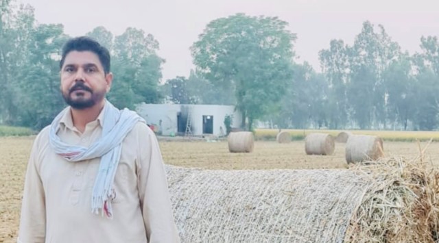 A farmer shows the paddy stubble bale ready to be picked by Ludhiana firm (Express)