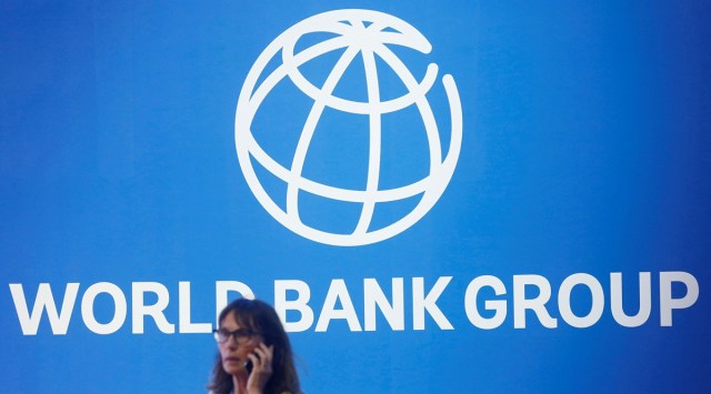 A participant stands near a logo of World Bank at the International Monetary Fund - World Bank Annual Meeting 2018 in Nusa Dua, Bali, Indonesia, October 12, 2018. (REUTERS/FILE)