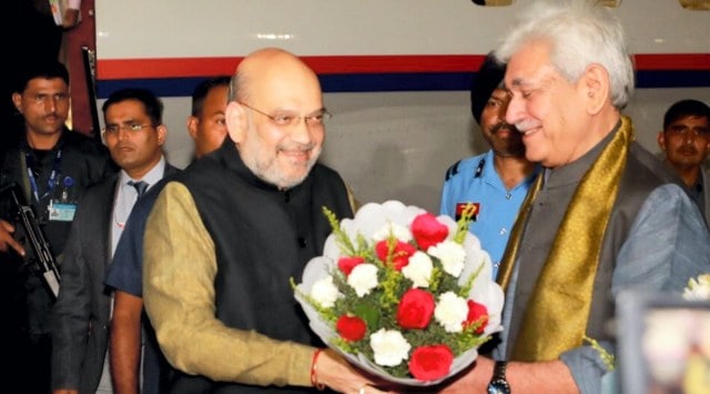 Union Home Minister Amit Shah being welcomed by J&K Lt. Governor Manoj Sinha upon his arrival in Jammu (PTI photo)