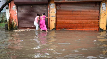 Guwahati: Commuters wade through a waterlogged street following rains in Guwahati, Tuesday, Oct. 11, 2022. (PTI Photo)