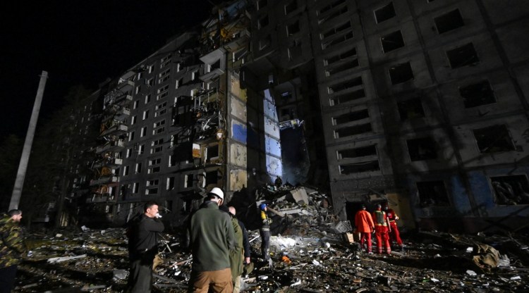 Rescuers work at a site of a residential building heavily damaged by a Russian missile strike, amid Russia's attack on Ukraine, in Zaporizhzhia, Ukraine October 9, 2022.  REUTERS/Stringer