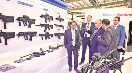 Delegates in a stall at the Defence Expo venue in Gandhinagar on Tuesday. (Express Photo)