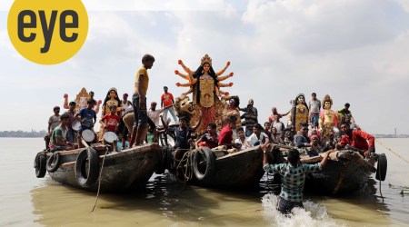 Devotees take the Goddess across the Hoogly, where she will be worshipped at the local barowari puja. (Photo credit: Partha Paul)

 