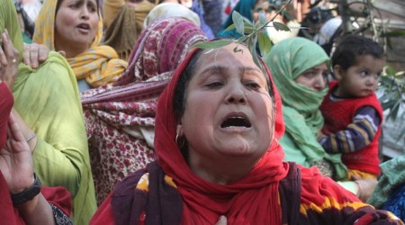 Grieving relatives and neighbours of Puran Kishan Bhat in Shopian (Express photo by Shuaib Masoodi)