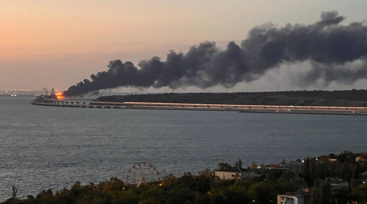A view shows a fire on the Kerch bridge at sunrise in the Kerch Strait, Crimea, Oct. 8, 2022. (Reuters)