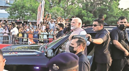Prime Minister Narendra Modi during a roadshow in Jamnagar on Monday. (Express Photo)