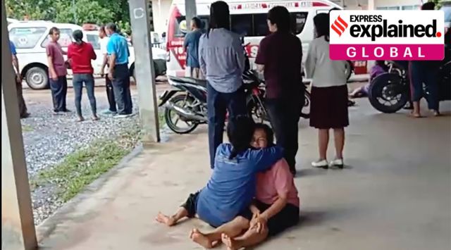 In this image taken from video, a distraught woman is comforted outside the site of an attack at a daycare center, Thursday, Oct. 6, 2022, in the town of Nongbua Lamphu, north eastern Thailand. (Mungkorn Sriboonreung Rescue Group via AP)