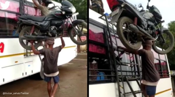 man balances bike on head, bike on head, man climbs bus ladder with bike on head, indian express