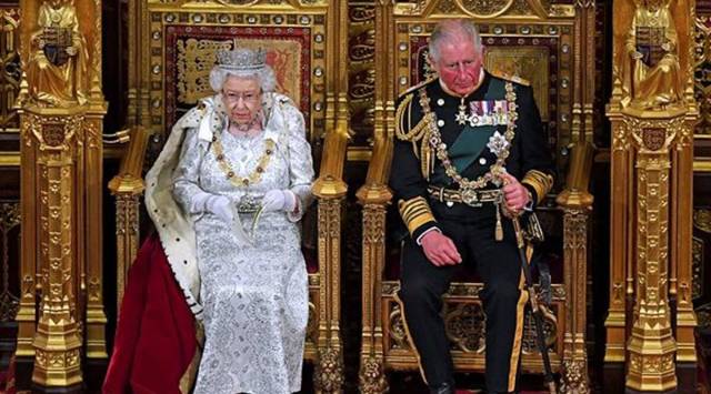 In this Oct. 14, 2019 file photo, Britain's Queen Elizabeth II, with Prince Charles, delivers the Queen's Speech at the official State Opening of Parliament in London. (Victoria Jones/Pool via AP, File)