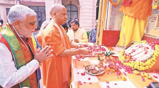 CM Yogi Adityanath and Union minister Ashwini Kumar Choubey offer prayers in Lucknow, Thursday. (Express Photo)