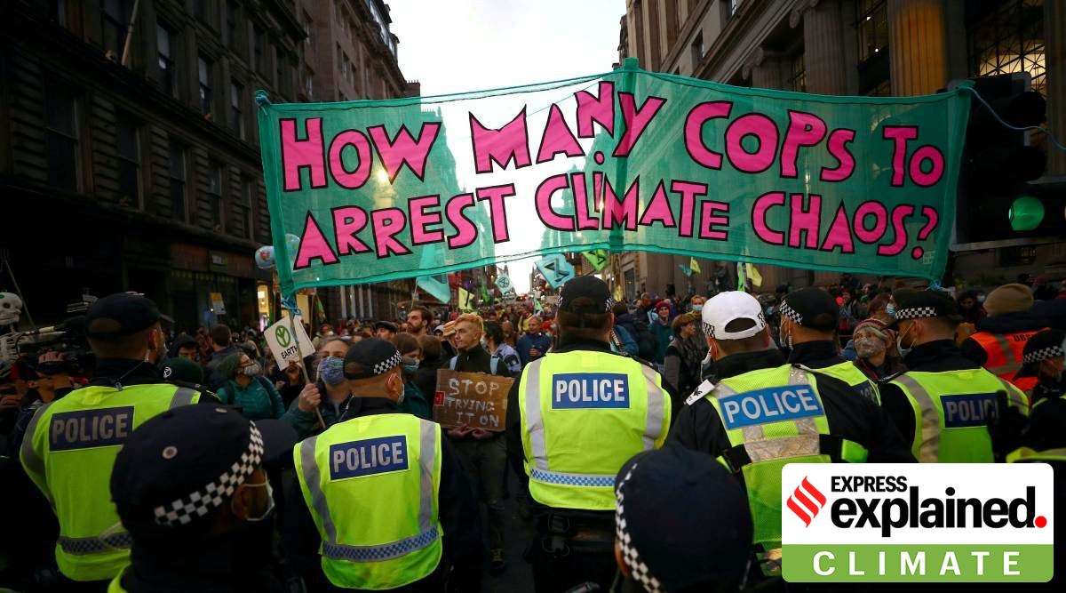 Extinction Rebellion activists stand in front of police officers as they protest during the UN Climate Change Conference (COP26) in Glasgow, Scotland, Britain, November 3, 2021 (Reuters Photo/File)