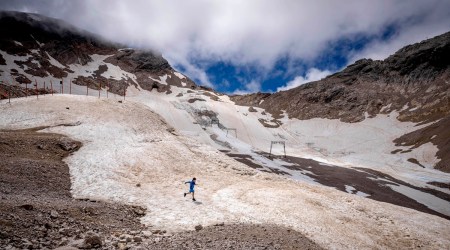 A youth runs over what remains of the glacier, that lost most of its volume during the last years, on top of the Zugspitze mountain near Garmisch-Partenkirchen, Germany. (AP, file)