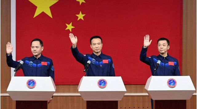 Astronauts Fei Junlong, Deng Qingming and Zhang Lu attend a news conference before the Shenzhou-15 spaceflight mission