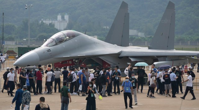 Visitors look at the J-16D electronic warfare variant of the Chinese military's J-16 airplane during 13th China International Aviation and Aerospace Exhibition, also known as Airshow China 2021 in Zhuhai, southern China, on Wednesday, Sept. 29, 2021. On Saturday, Nov. 12, 2022, China's military flew 36 fighter jets and bombers near Taiwan, the Taiwanese defense ministry announced, part of a long-running campaign of intimidation against the self-ruled island democracy that Beijing claims as part of its territory. (AP Photo)