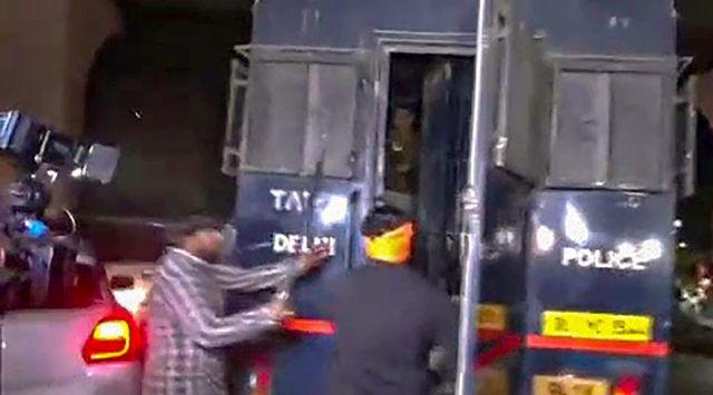 Sword-wielding men from Hindu Sena try to allegedly attack Aaftab Poonawala, accused in the Mehrauli murder case, as he is transported in a police van in New Delhi, Monday, Nov. 28, 2022. (PTI Photo) 