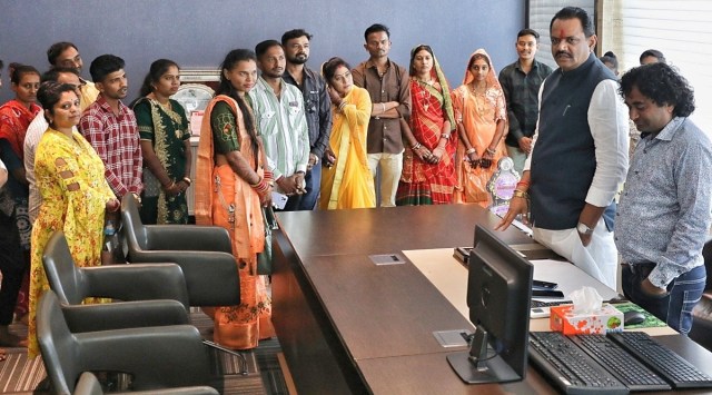 Education Minister Jitu Vaghani and Suresh Lakhani from the Maruti Impex Foundation meet the newly wed couples on Tuesday. (Express photo by Nirmal Harindran)