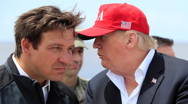 President Donald Trump talks to Florida Gov. Ron DeSantis, left, on March 29, 2019. (AP Photo)