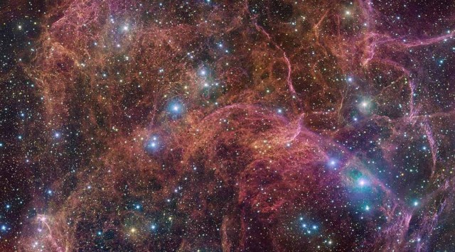 An undated image shows a view of the orange and pink clouds that make up what remains after the explosive death of a massive star - the Vela supernova remnant. This image consists of 554 million pixels and is a combined mosaic image of observations taken with the 268-million-pixel OmegaCAM camera at the VLT Survey Telescope, hosted at ESO’s Paranal Observatory. OmegaCAM can take images through several filters that each let the telescope see the light emitted in a distinct color. To capture this image, four filters have been used, represented here by a combination of magenta, blue, green and red. The result is an extremely detailed and stunning view of both the gaseous filaments in the remnant and the foreground bright blue stars that add sparkle to the image. ESO/VPHAS+ team/Cambridge Astronomical Survey Unit/Handout via REUTER