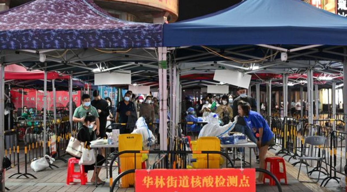 People line up to take nucleic acid test for the coronavirus disease (COVID-19) following the outbreak, at a makeshift testing site in Guangzhou, Guangdong province, China. (Reuters)