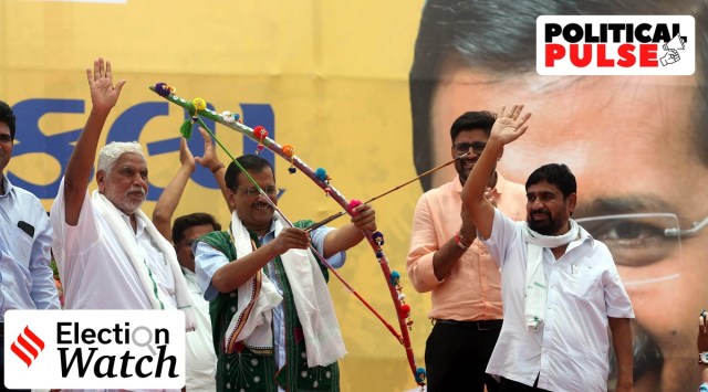 Bharatiya Tribal Party (BTP) leader Chhotubhai Vasava (Left) and son Mahesh (Right) with Delhi Chief Minister Arvind Kejriwal at Chanderiya village in south Gujarat's Bharuch district. (Express photo by Bhupendra Rana)