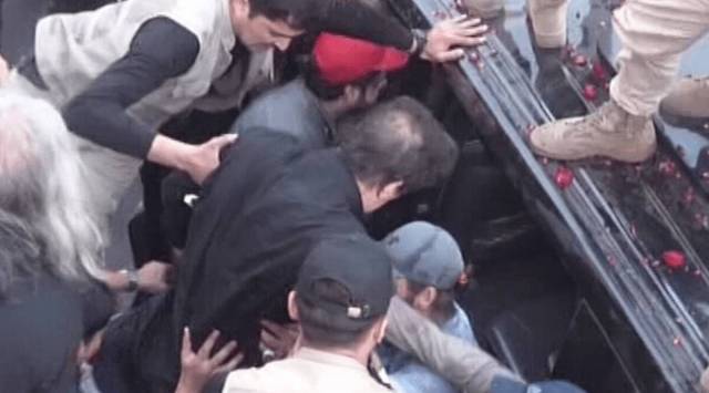 Television footage showed Imran Khan being hustled into a car after the shots were fired. (Photo Credit: Dawn)